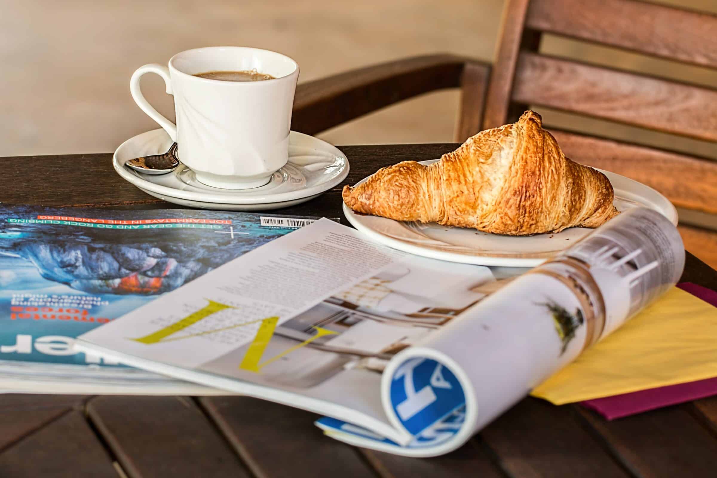 Newspapers coffee croissant