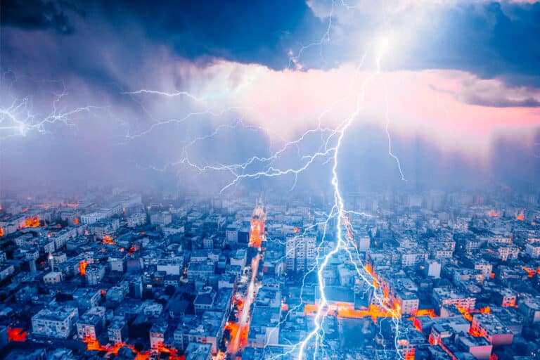 Lightning thunderstorm flash over the city at blue night sky - L